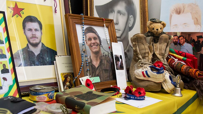 A shrine to Ashley Johnston in his mother's home, including photos, his boots, a Bible and other personal items.