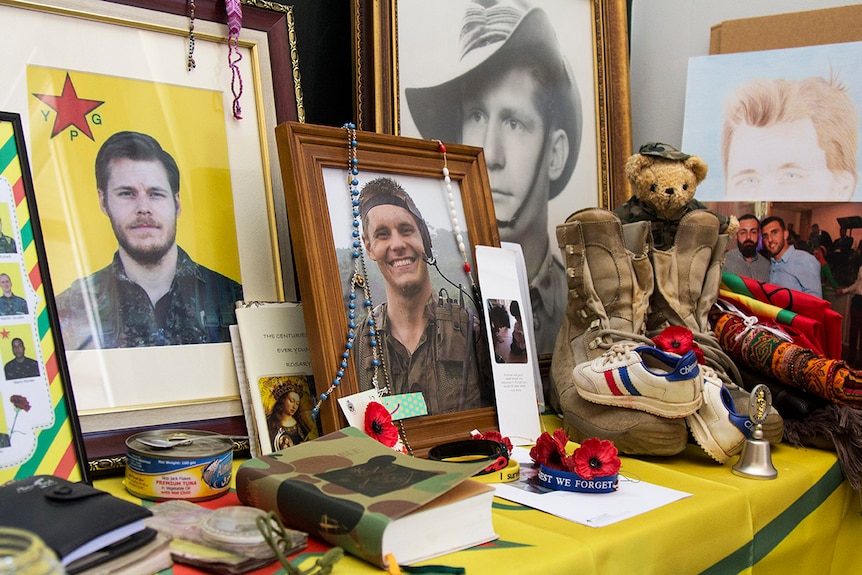 A shrine to Ashley Johnston in his mother's home, including photos, his boots, a Bible and other personal items.