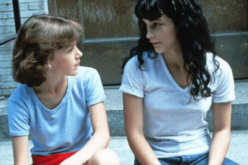 Still from the 1984 film Old Enough with two girls sitting on a stoop