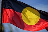 An Australian Aboriginal flag waving in the wind.