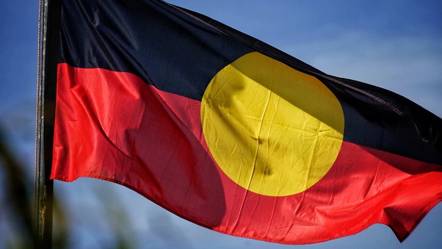 An Australian Aboriginal flag waving in the wind.