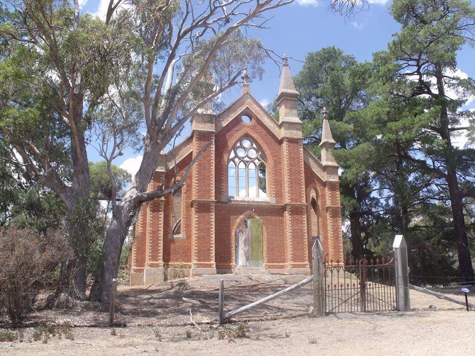 The front of an old church. The main body of the church is missing after being burned down.