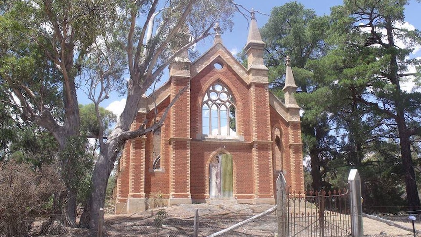 The front of an old church. The main body of the church is missing after being burned down.