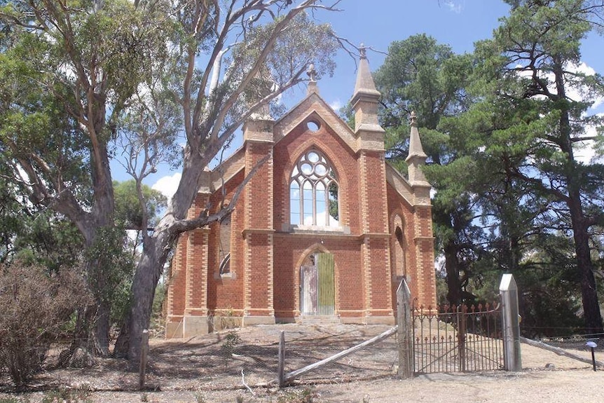 The front of an old church. The main body of the church is missing after being burned down.