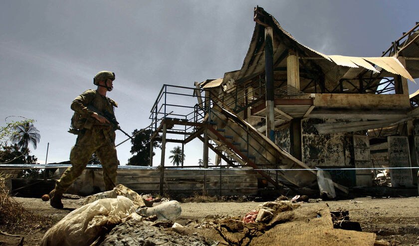 Australian soldier patrols Honiara's Chinatown district
