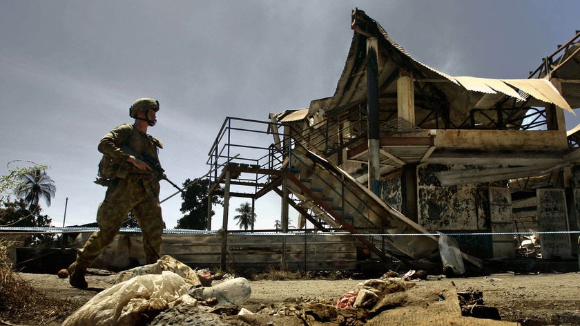 Australian soldier patrols Honiara's Chinatown district