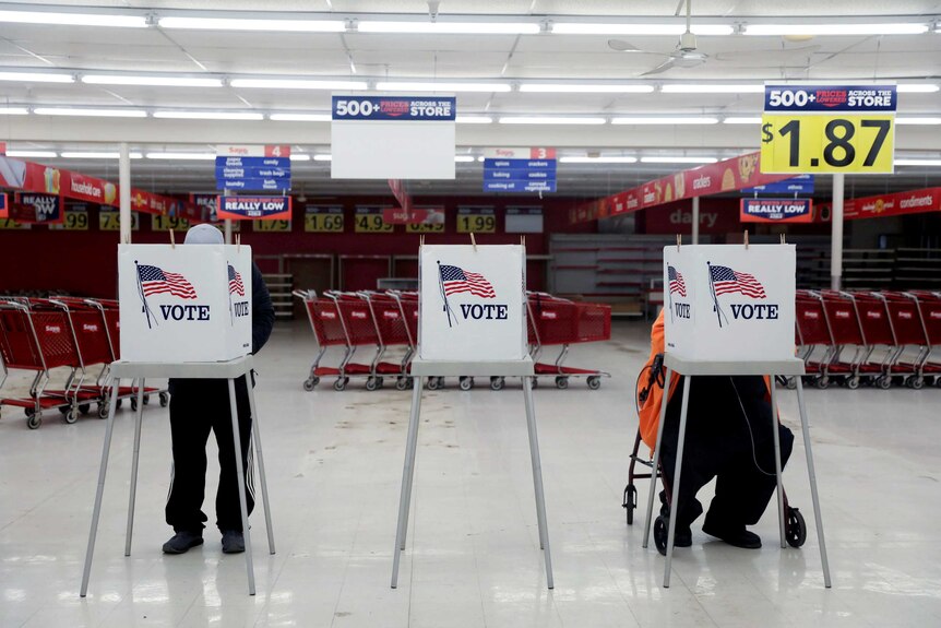 Voters fill out ballots during the primary election in Ottawa, Illinois