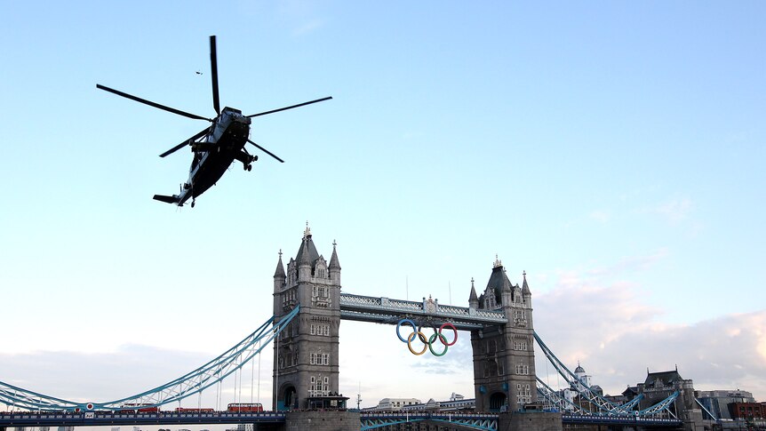 The Olympic flame arrives in London onboard a Sea King Helicopter above Tower Bridge