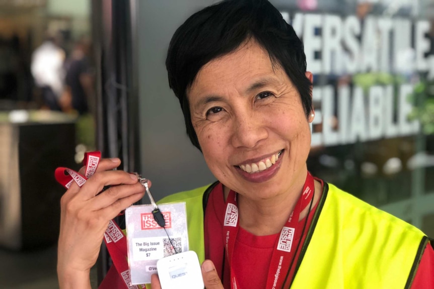 The Big Issue seller, Pat, shows the new technology she's being trained to use