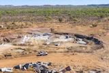 An aerial photograph shows a ute making its way through a Kimberley mining site.
