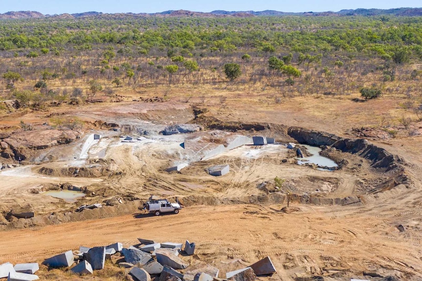 An aerial photograph shows a ute making its way through a Kimberley mining site.