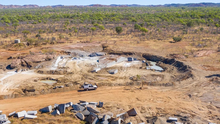 An aerial photograph shows a ute making its way through a Kimberley mining site.