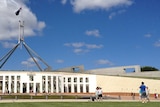People take photos outside Parliament House