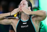 Cate Campbell holds both hands to her face, blowing a kiss towards the crowd