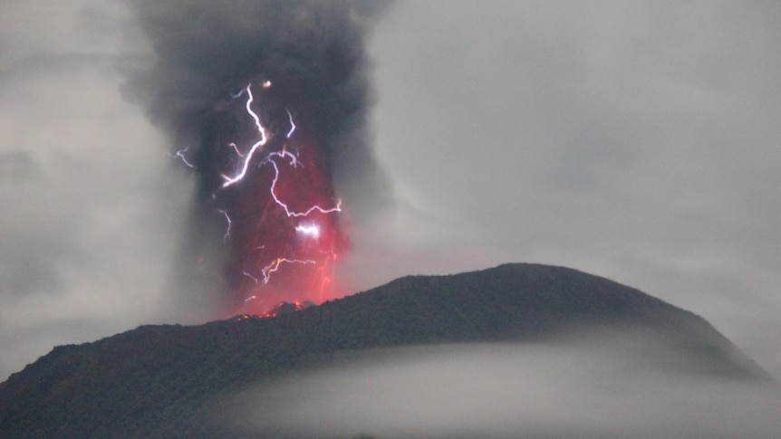Lightning appears amid a storm as Mount Ibu spews volcanic material during an eruption, as seen from Gam Ici in West Halmahera, 
