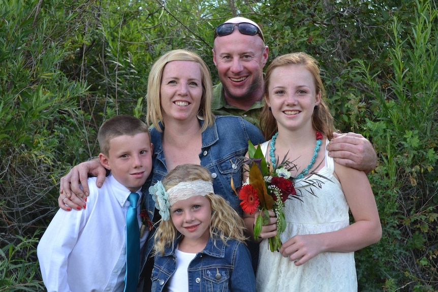 A man with his wife and three children