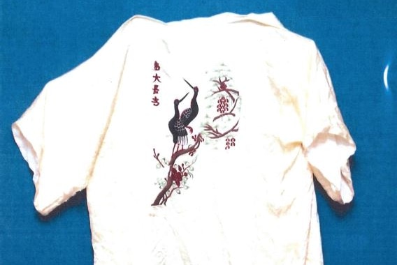 A white silky kimono with an oriental-style image of two birds across the back.