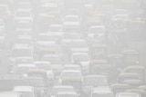 Vehicles drive through heavy smog in Delhi.