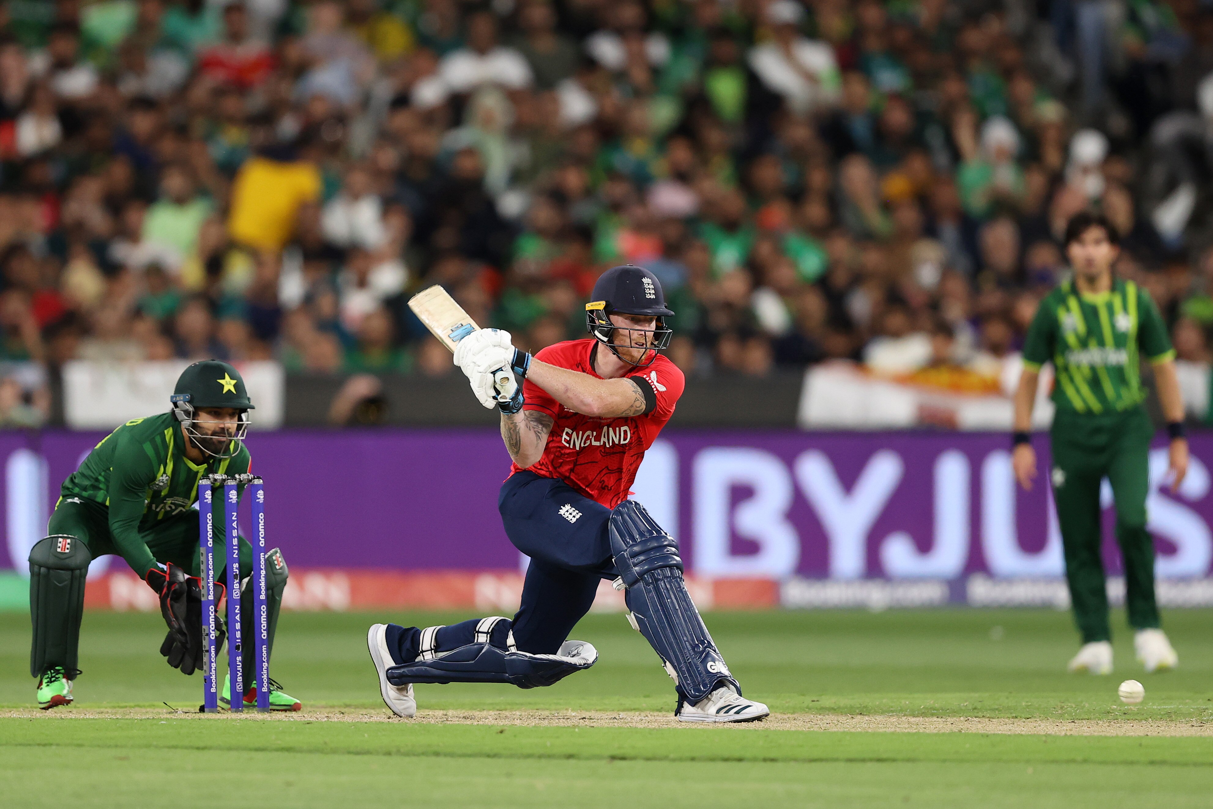 Ben Stokes attempts a reverse sweep while the Pakistan wicketkeeper and fielders watch on