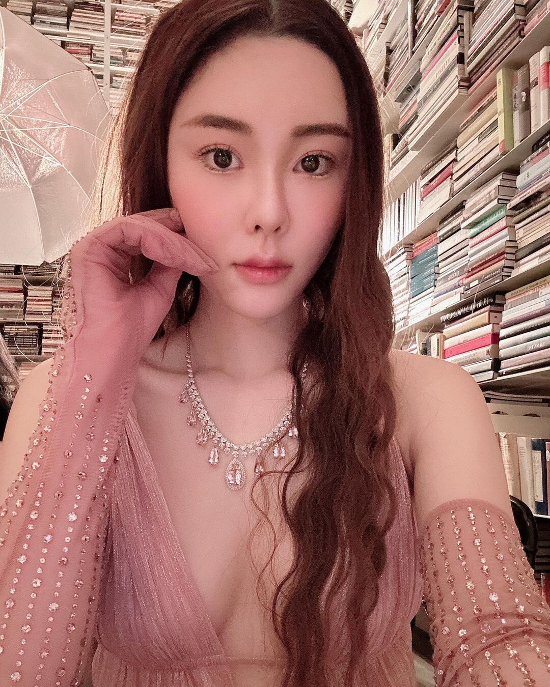 Abby Choi poses with a neutral expression in a selfie taken at her home.