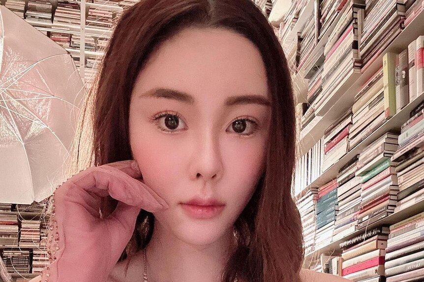 Abby Choi poses with a neutral expression in a selfie taken at her home.
