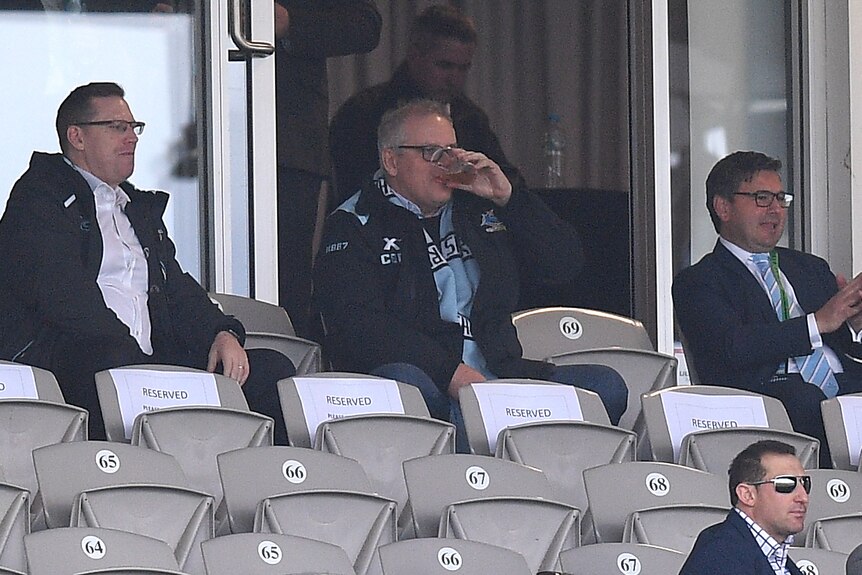 Scott Morrison watches on from the stands during the NRL match between the Sharks and the Panthers.