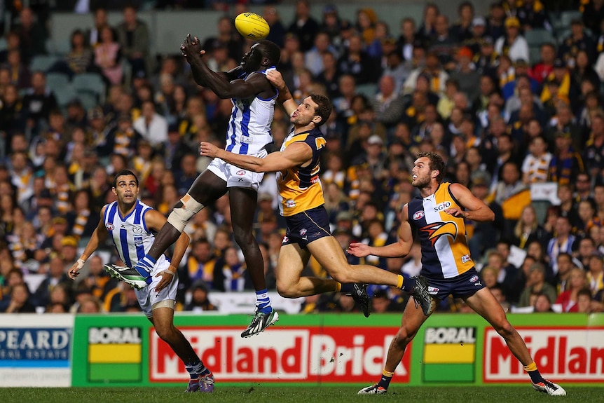 The Kangaroos' Majak Daw is spoiled by West Coast's Darren Glass at Subiaco Oval.