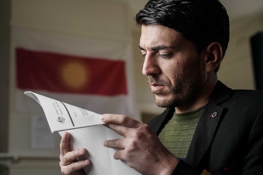 A man looks at documents.