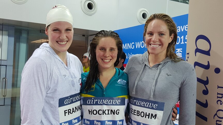 Swimmers Missy Franklin, Belinda Hocking and Emily Seebohm standing side by side.