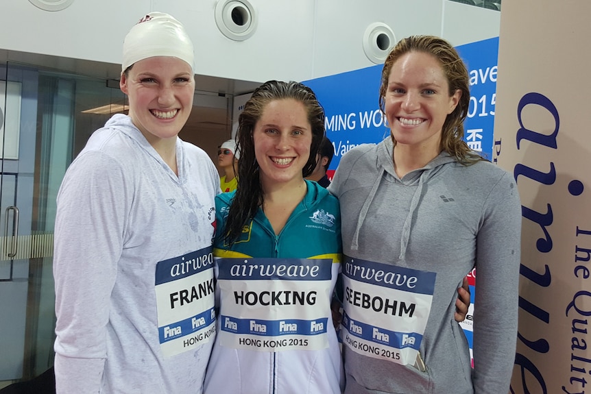 Swimmers Missy Franklin, Belinda Hocking and Emily Seebohm standing side by side.