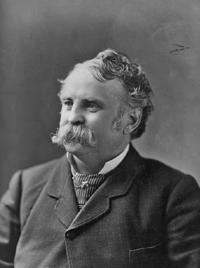 A black and white portrait of Charles Mosher, a balding man with a thick white moustache, looking off to the left.