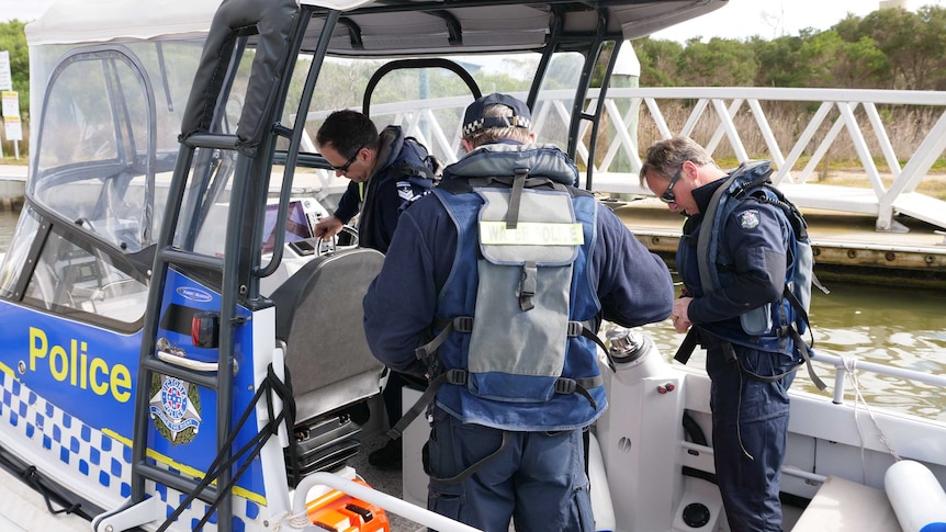 police divers on a boat