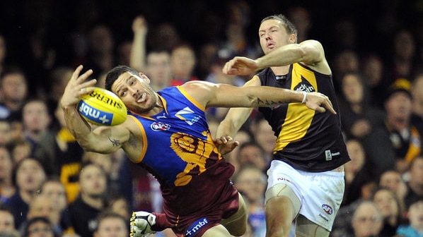 Virtually absent: Fevola's (l) lone goal of the night came after this contested mark against Will Thursfield.