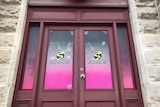 Wooden doors with pink signage saying Shadows
