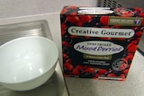 Package of Creative Gourmet frozen mixed berries beside a bowl