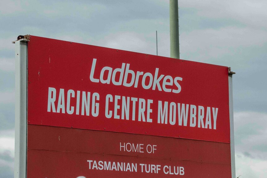 Ladbrokes signage is above a sign for the Tasmanian Turf Club in Mowbray.