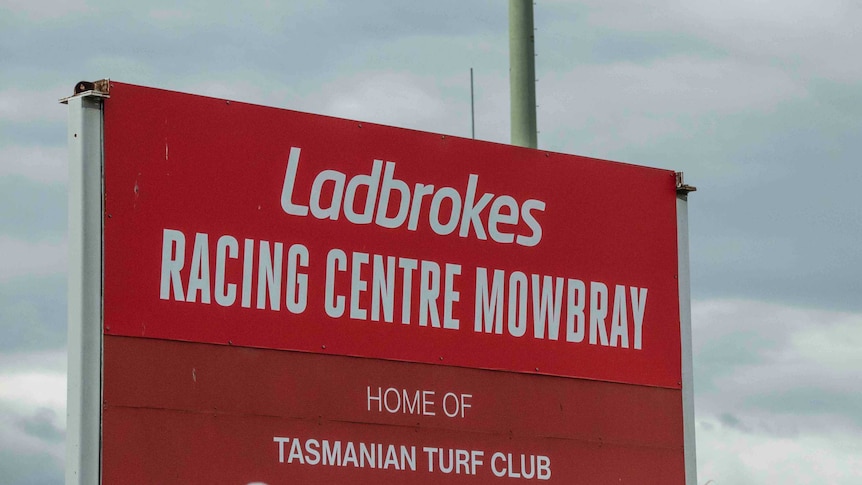 Ladbrokes signage is above a sign for the Tasmanian Turf Club in Mowbray.