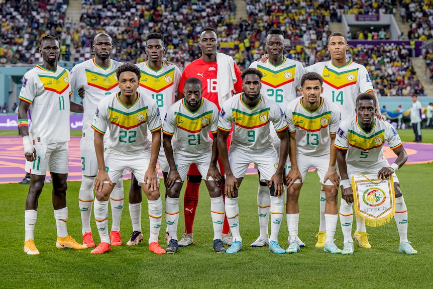 Senegal's starting line-up pose together for a photo ahead of the FIFA World Cup Qatar 2022 Group A match against Ecuador.