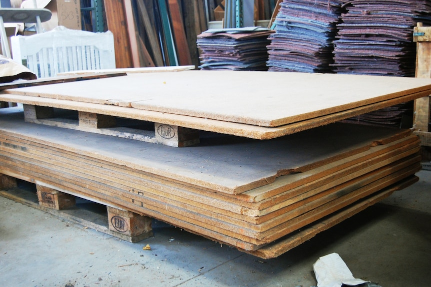 Sheets of particle board in a store.