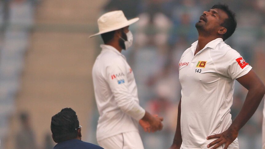 Sri Lanka's Lahiru Gamage appears to struggle to breathe as he is attended by a trainer.