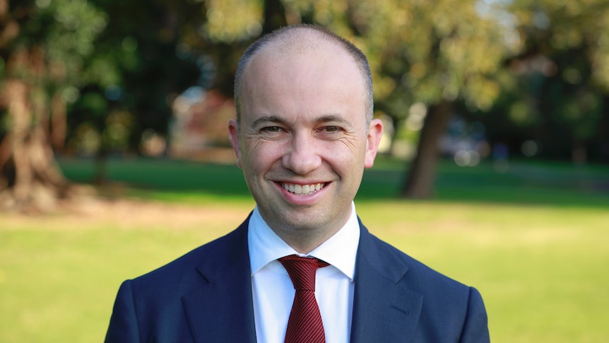 A man smiles at the camera.