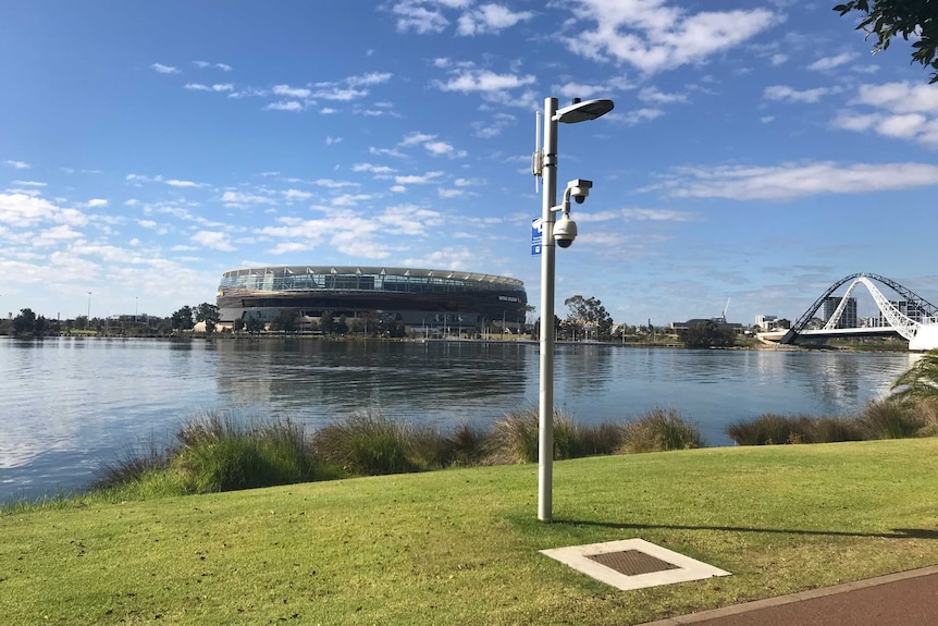 A CCTV camera in East Perth, with the river and Perth Stadium in the background.
