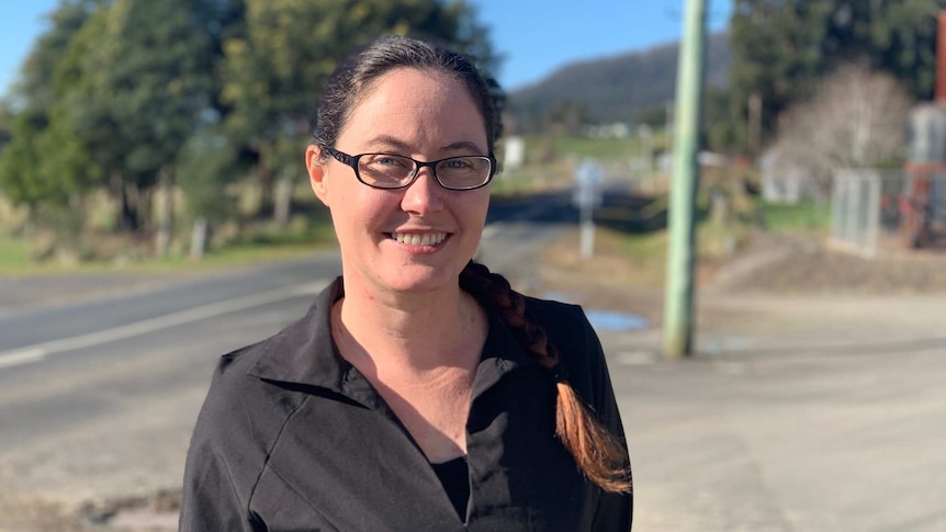 Rachel Power, a cafe owner, smiles in the street