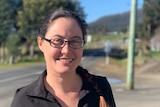 Rachel Power, a cafe owner, smiles in the street