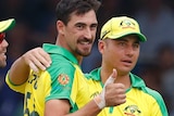 Mitchell Starc, flanked by Glenn Maxwell and Marcus Stoinis, smiles and gives a thumbs up.