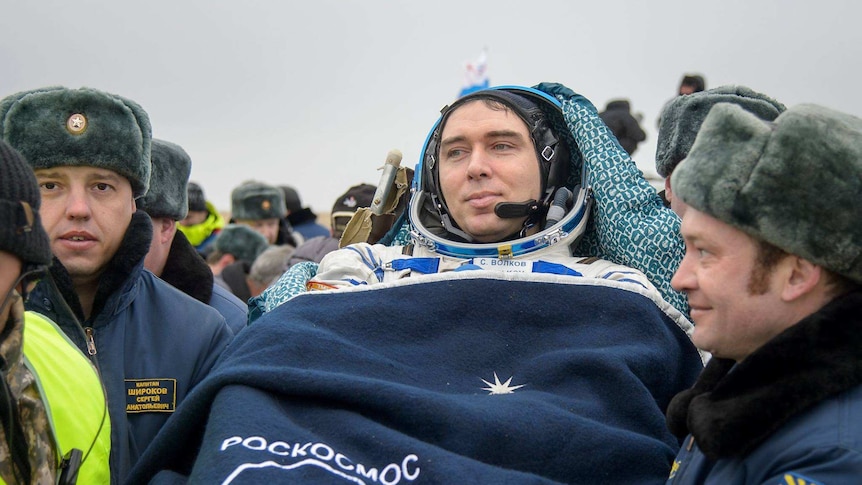 Russian cosmonaut Sergey Volkov of Roscosmos is carried into a medical tent