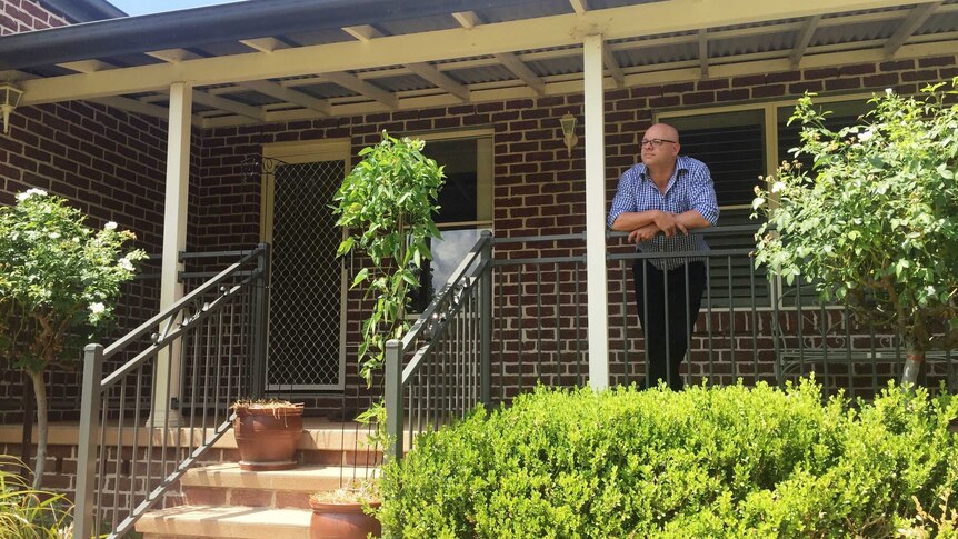 Mitch Williams leans on the verandah of his father's home.