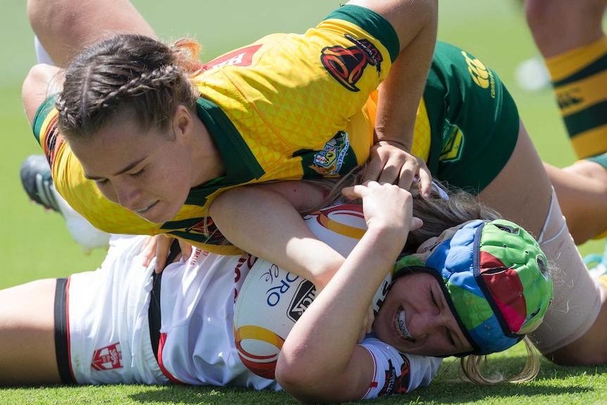 Isabelle Kelly of Australia tackles Jodie Cunningham of England.