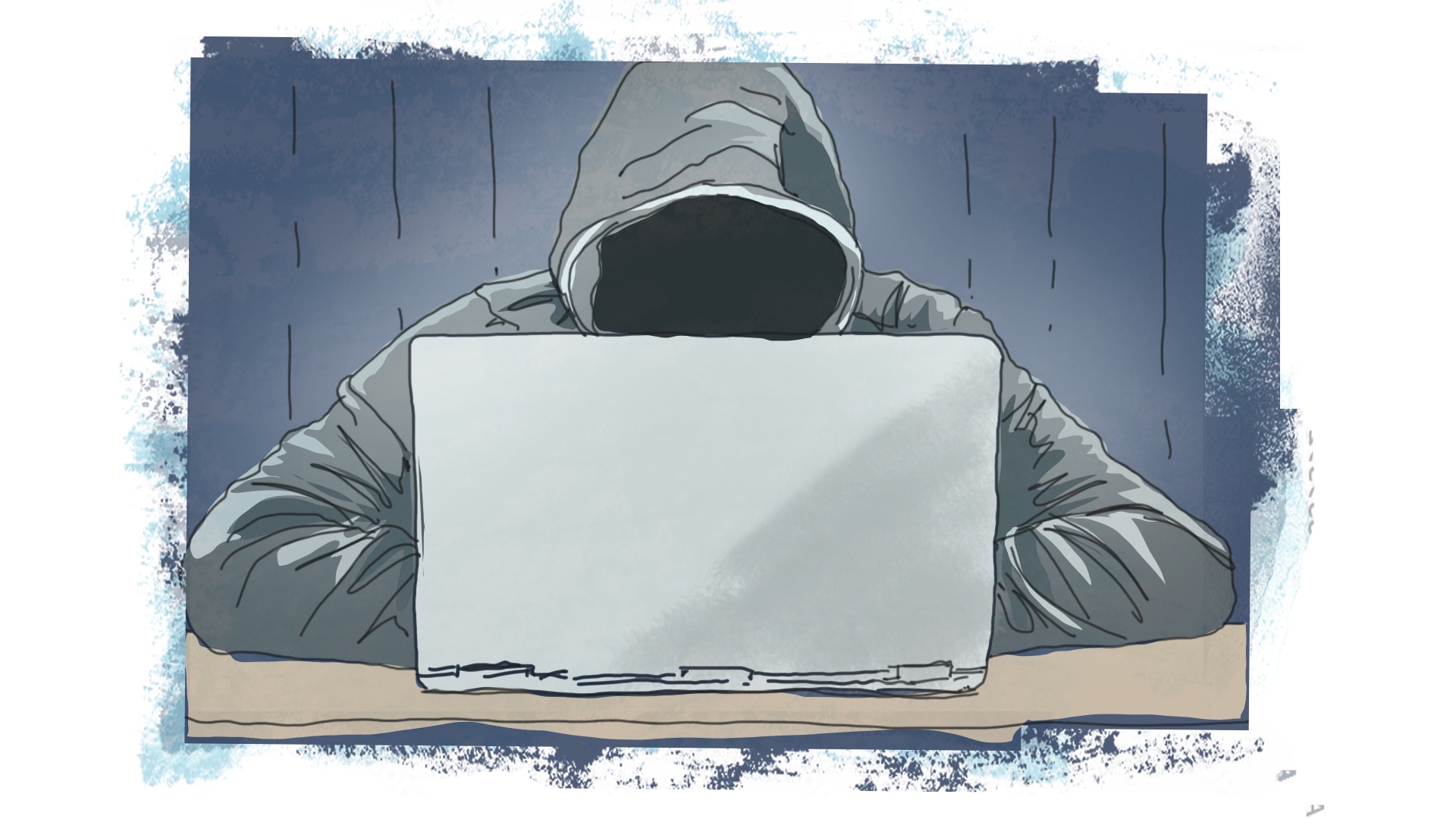 Um homem vestindo um moletom com capuz e um laptop. 