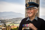 Brian Winspear AM in his home with six medals for his service.